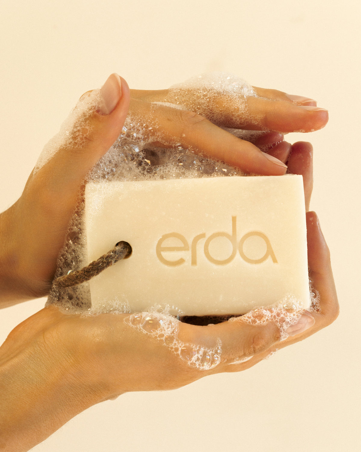 Lathering Erda Organic Tallow Bar Soap between hands - rich creamy lather from grass-fed tallow soap