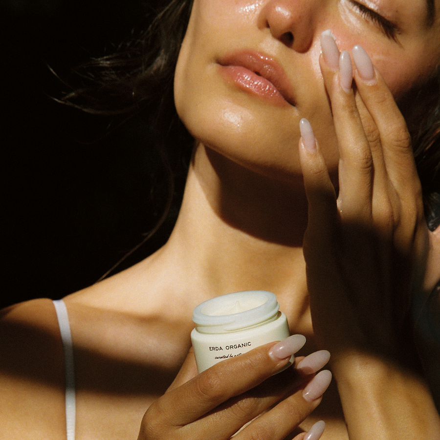 Woman applying Erda Organic Face Balm - tallow face moisturizer for glowing skin