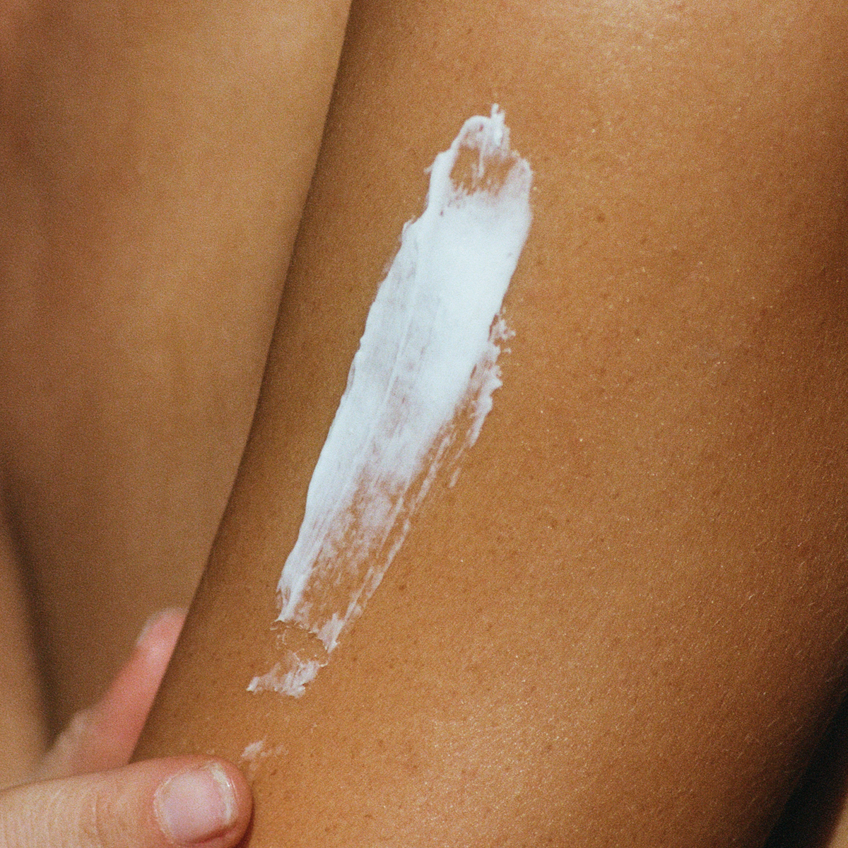 Applying Erda Organic Tallow Body Balm to skin - natural tallow moisturizer for deep hydration